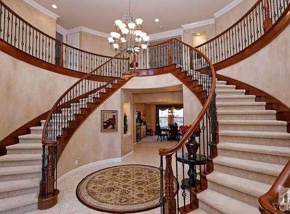 Beautiful Mahogany staircase with wrought iron, look straight through to back yard views