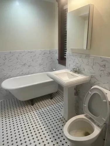 Completely renovated large tiled bath/laundry room with a soaking tub - 185 Pine St