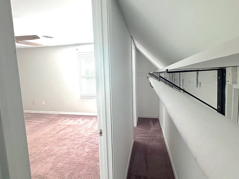 his and hers closets in both upstairs bedrooms feature a bar spanning full width of bedroom, perfect for storage and ample closet space