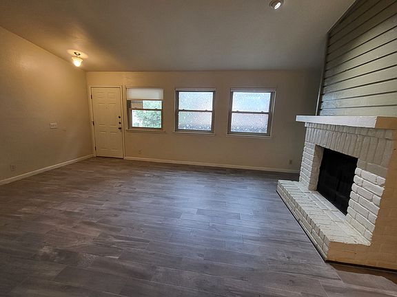 Spacious living room with fire place. New tiles all of downstairs!