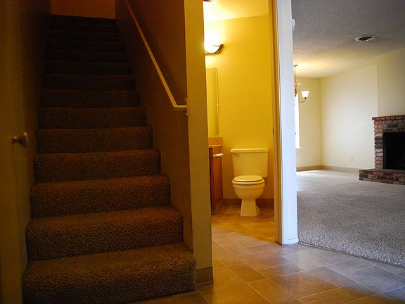 Downstairs 1/2 bath, stairs, and living room