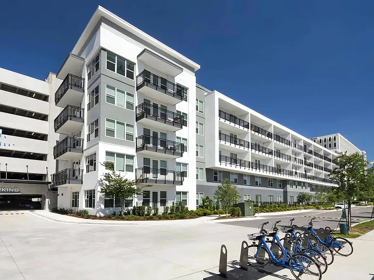 Anchor Riverwalk Community Building with Adjacent Parking Garage and Bike Share Station