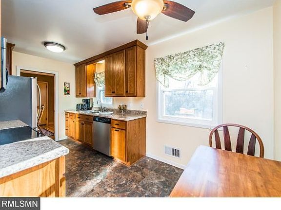 Tiled Kitchen with updated Oak shaker cabinets and stainless appliances.