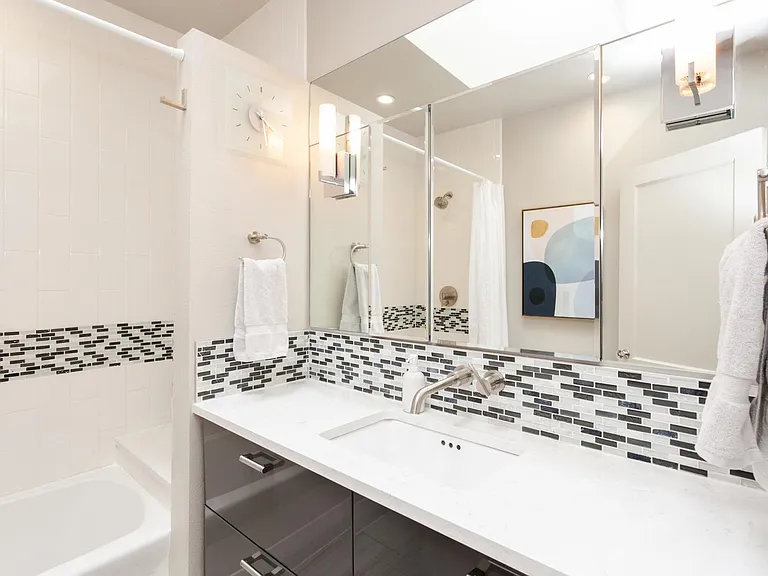 Bathroom, single sink, tons of storage in drawers and large medicine cabinets