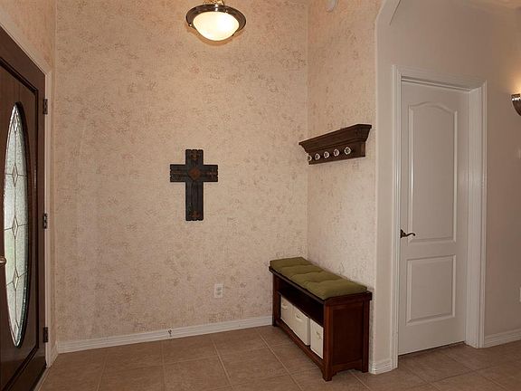 Textured sponge painting in neutral colors adds interest in the pretty foyer...