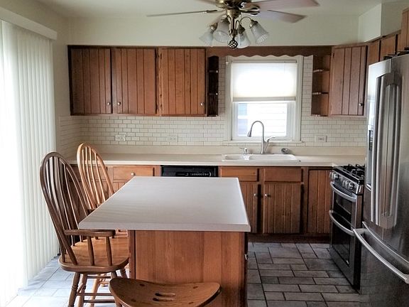 Kitchen with Porcelain Floors Stainless Steel Frig and Stove