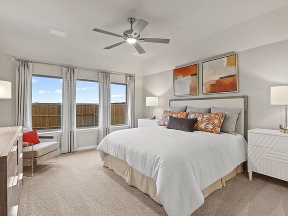 Primary bedroom in the Heisman home plan by Trophy Signature Homes - REPRESENTATIVE PHOTO