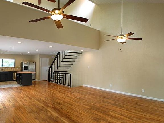Living area has dramatic peaked ceiling and partial vie of the loft space