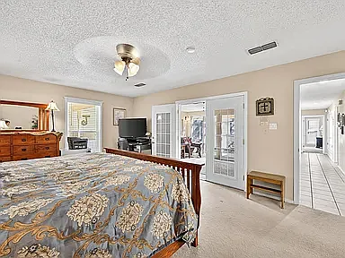 Primary bedroom looking into sunroom
