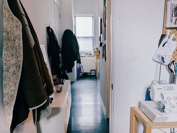 Hallway near main entrance. View is from inside of Bedroom #1 looking towards the door. Bathroom entrance is to the right.