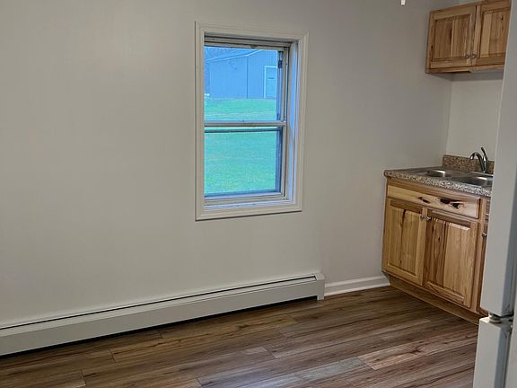 Kitchen- new cabinets, counter, flooring, sink, ceiling fan. Enough room for a table/breakfast nook