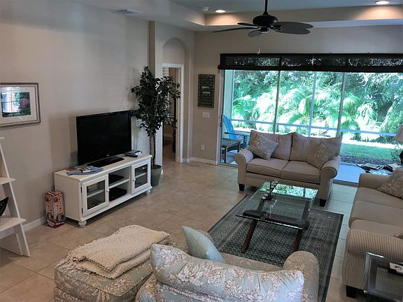 Living Room leading out to Screened Lanai Area.