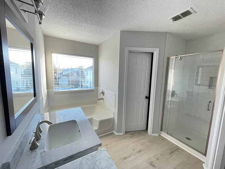 Master bathroom has separate shower and bathtub