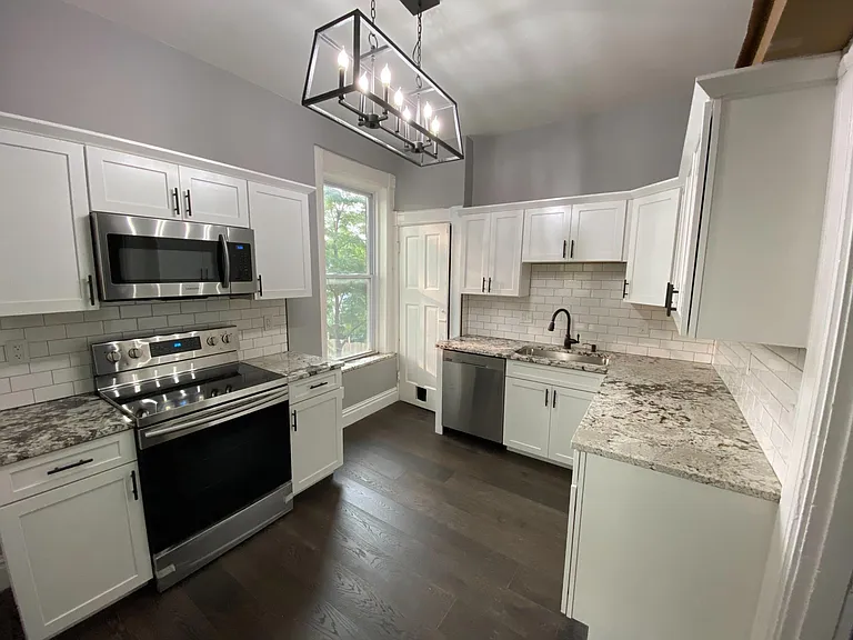 2nd Floor Kitchen! GRANITE, SAMSUNG APPLIANCES, SUBWAY TILE, NEW LIGHTING, LIFEPROOF OAK FLOORS, CUSTOM CABINETS with soft close drawers and crown moulding!