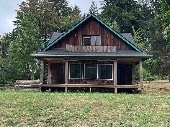 Back of house with view of wraparound porch