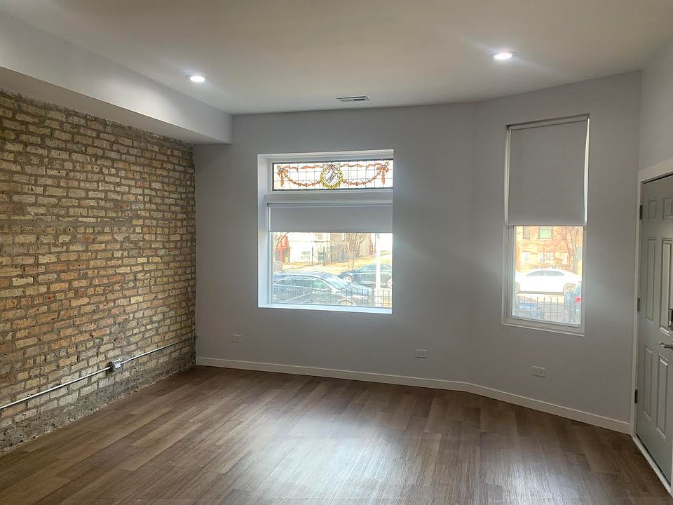 Cozy front room with exposed brick and large windows