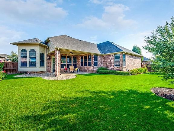 Rear elevation. Full sprinkler system with rain freeze sensor. Full gutters.  Nice yard for play!