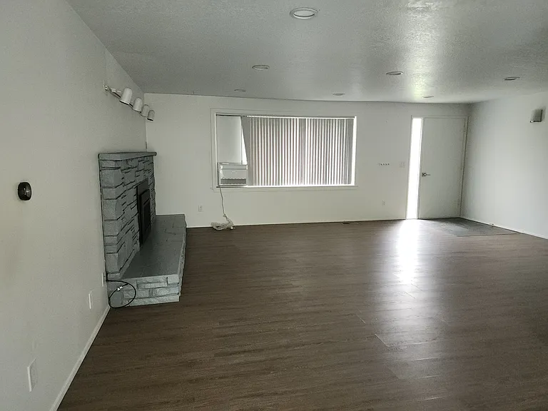 Front door entrance to spacious living room. Air Conditioning in main living space.
