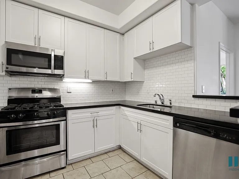 Kitchen with Stainless-Steel Stove, Microwave Oven, Dishwasher and Countertop Bar