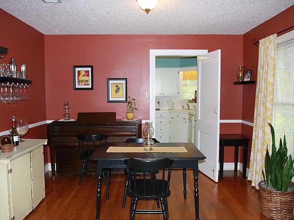 Stylist formal dining room with French doors leading to living room
