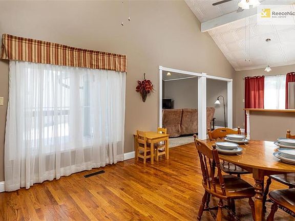 Large dining area with vaulted ceilings and hardwoods.