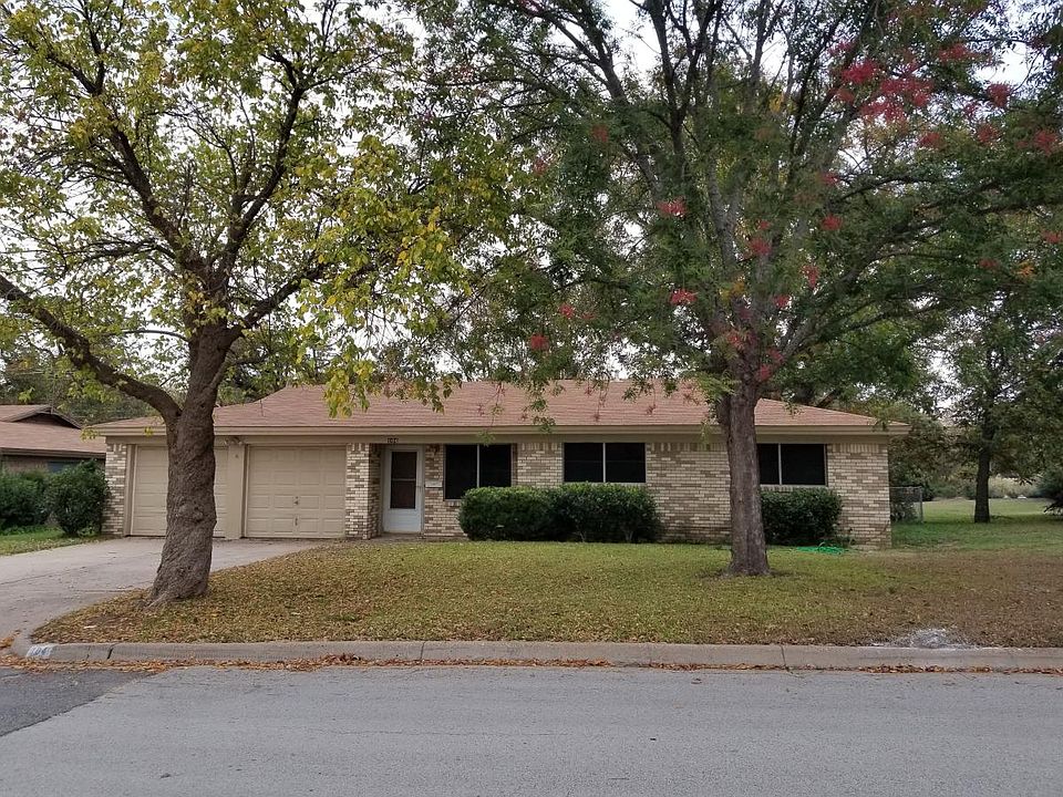 Shaded front yard with two-car garage