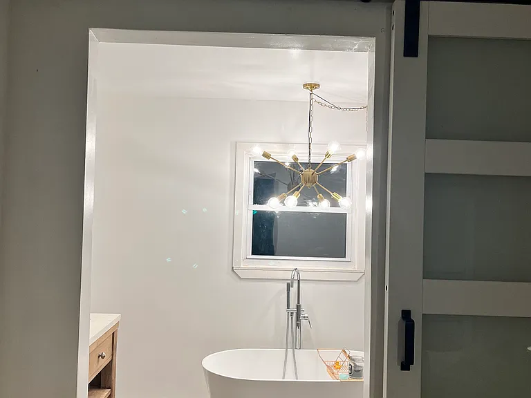 Spa like primary bathroom with barn doors