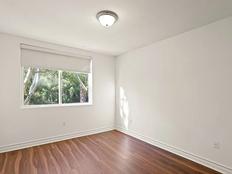 Bedroom with Large-Size Window and Vinyl Flooring