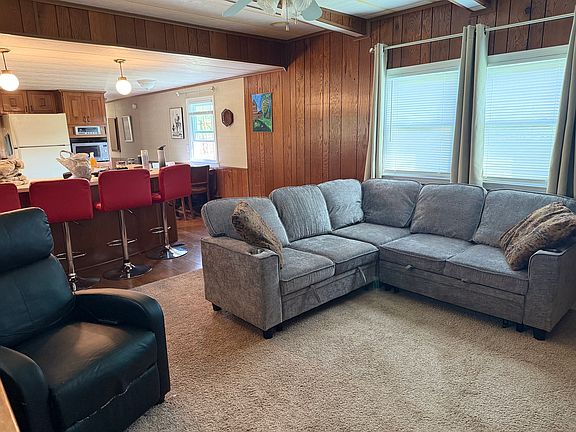 Spacious living room with sleeper couch and massage recliner