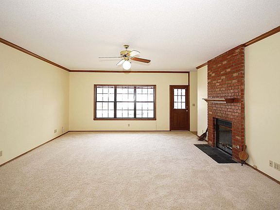Living area with see thru fireplace, new carpet, crown molding.