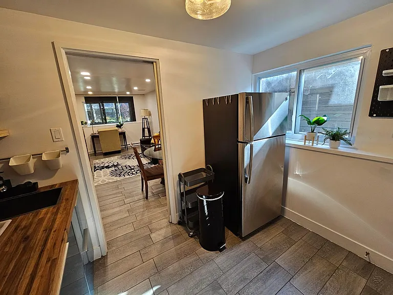 Kitchen view with refrigerator.