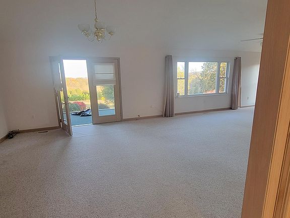 Extra large living room with double doors open to screened in back patio.