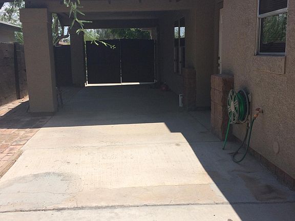 Side of house/yard. View of front automatic gate.