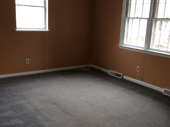 Living room looking at front and side window.