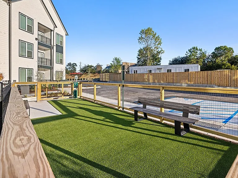 Pet-friendly apartment community with fenced dog park, pet relief area, and outdoor space for pets to play.
