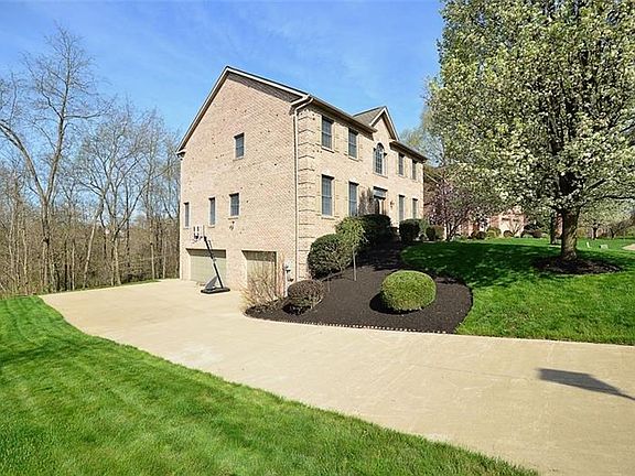 The level entry to the front door, concrete driveway to the side entry 3 car garage and private treed lot and all brick 2x6 cons