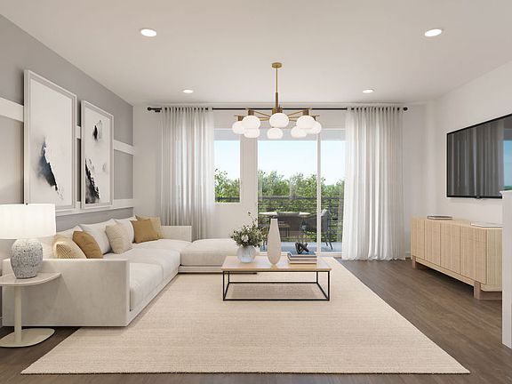 Gathering room with sliding glass door and balcony access