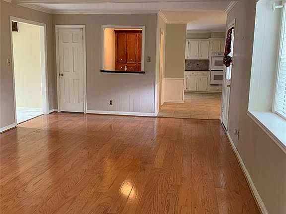 In the back of family room is a wet bar with sink and cabinets. Great for entertaining.