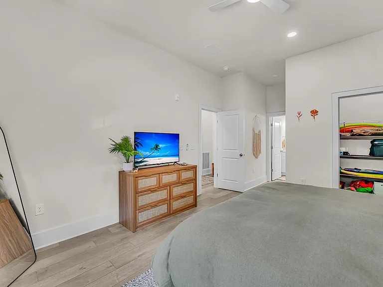A large walk in closet with shelving and hanging racks