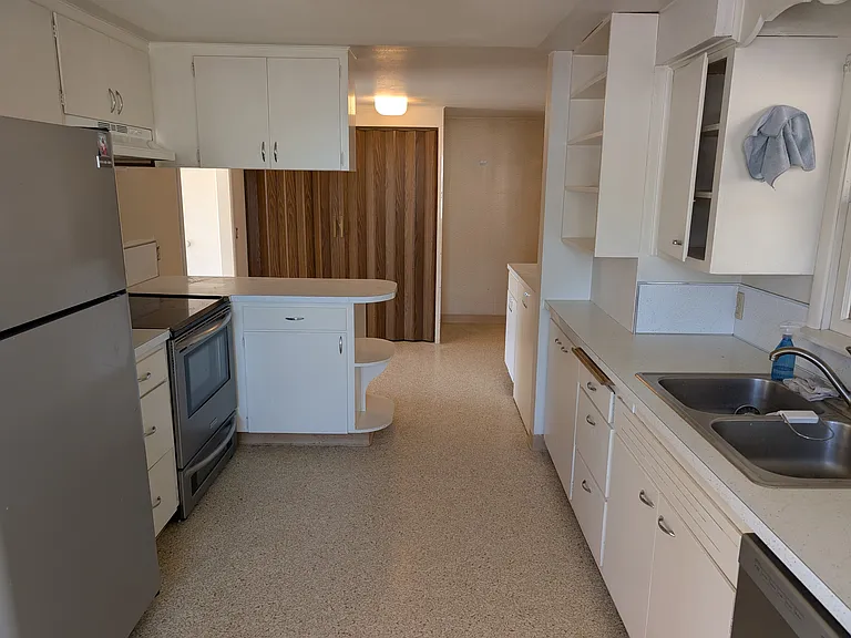 Kitchen with laundry closet in background