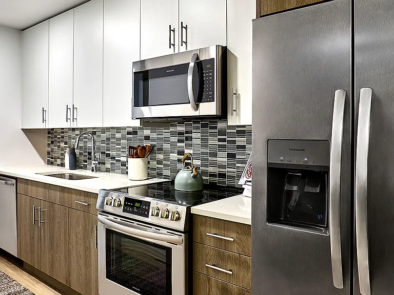 Apartment Kitchen with Stainless Steel Appliances and Quartz Countertops
