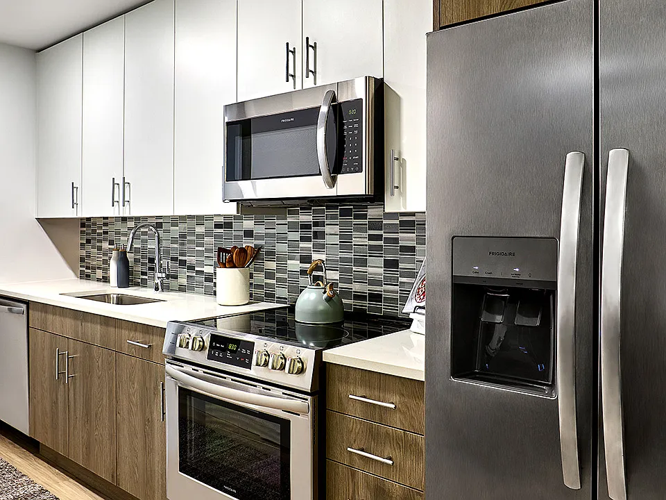 Apartment Kitchen with Stainless Steel Appliances and Quartz Countertops