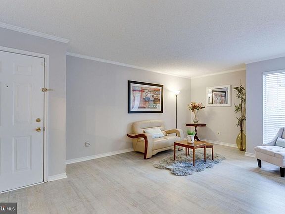 another living room's view with entrance door.