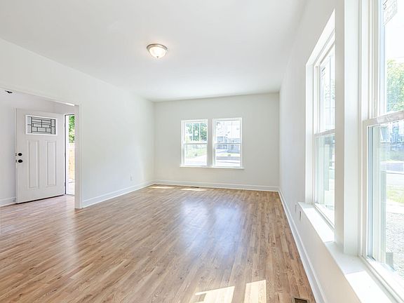 Open concept living room with dinning room behind it (very spacious to fit full dining table and living room set)