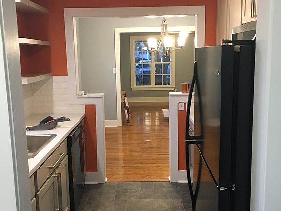 Kitchen looking into dining room, then living room beyond.