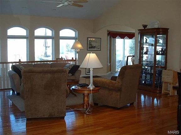 Vaulted Great Room with wood floors, wall of windows & fireplace!