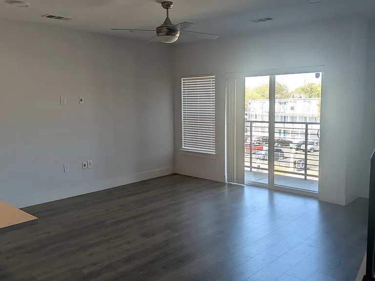 Living area and access to private balcony overlooking Manor Rd.