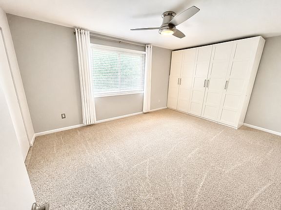 Primary bedroom with two closets and large custom wardrobe. En suite bathroom.