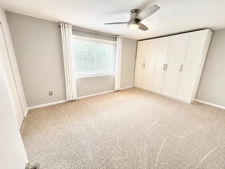 Primary bedroom with two closets and large custom wardrobe. En suite bathroom.