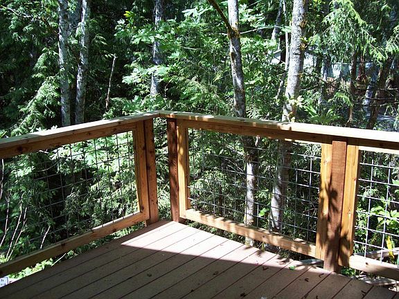 Deck w/ creek in backyard